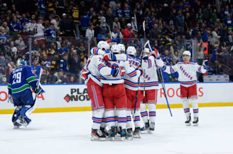 VANCOUVER, CANADA – OCTOBER 28: The New York Rangers celebrate an overtime win as Casey DeSmith #29 of the Vancouver Canucks skates on during their NHL game at Rogers Arena on October 28, 2023 in Vancouver, British Columbia, Canada. (Photo by Derek Cain/Getty Images)