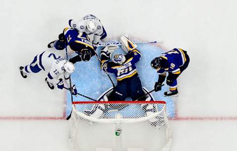 ST LOUIS, MO – NOVEMBER 30: Goalie Jordan Binnington #50 and Robert Thomas #18 of the St. Louis Blues defend the net against Alex Barre-Boulet #12 of the Tampa Bay Lightning during the second period at Enterprise Center on November 30, 2021 in St Louis, Missouri. (Photo by Jeff Curry/Getty Images)