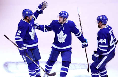 TORONTO – APRIL 23: From left, Toronto Maple Leafs defenseman Ron Hainsey, center Mitchell Marner and defenseman Morgan Rielly celebrate Marner’s goal in the second period. The Toronto Maple Leafs host the Boston Bruins in Game 6 of the Eastern Conference First Round during the 2018 NHL Stanley Cup Playoffs at the Air Canada Centre in Toronto, Ontario on April 23, 2018. (Photo by Barry Chin/The Boston Globe via Getty Images)