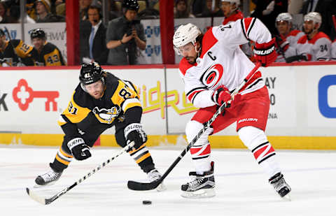 PITTSBURGH, PA – JANUARY 04: Justin Faulk #27 of the Carolina Hurricanes handles the puck against Phil Kessel #81 of the Pittsburgh Penguins at PPG Paints Arena on January 4, 2018 in Pittsburgh, Pennsylvania. (Photo by Joe Sargent/NHLI via Getty Images)