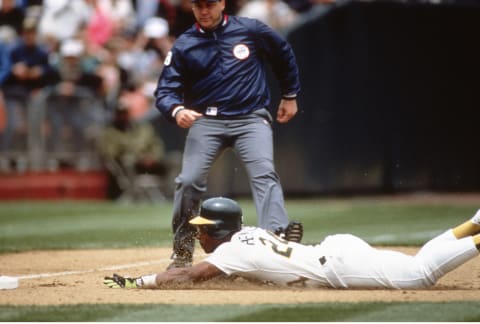 OAKLAND, CA – MAY 1: Outfielder Rickey Henderson #24 of the Oakland Athletics steals third base against the New York Yankees during a Major League Baseball game May 1, 1991 at the Oakland-Alameda County Coliseum in Oakland, California. The stolen base was 939 for Henderson breaking the record of 938 held by former St. Louis Cardinal Lou Brock. (Photo by Focus on Sport/Getty Images)