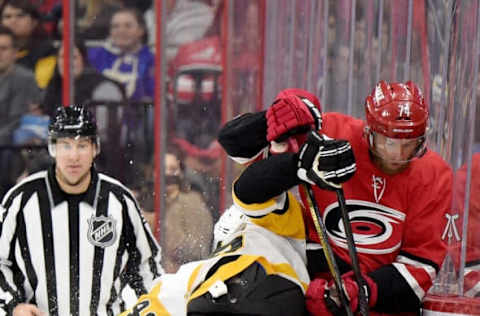 RALEIGH, NORTH CAROLINA – DECEMBER 22: Riley Sheahan #15 of the Pittsburgh Penguins checks Jaccob Slavin #74 of the Carolina Hurricanes during their game at PNC Arena on December 22, 2018, in Raleigh, North Carolina. (Photo by Grant Halverson/Getty Images)