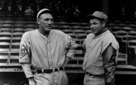 Chuck Klein of the Philadelphia Phillies (left) and Jimmie Foxx of the Philadelphia Athletics, both lean on bats as they converse in front of the dugout, circa 1930. (Photo by The Stanley Weston Archive/Getty Images)