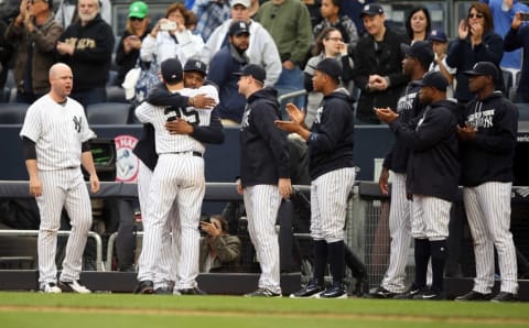 Oct 2, 2016; Bronx, NY, USA; New York Yankees first baseman Mark Teixeira (25) is embraced by starting pitcher CC Sabathia (52) after being removed from his final Major League game against the Baltimore Orioles at Yankee Stadium. Mandatory Credit: Danny Wild-USA TODAY Sports