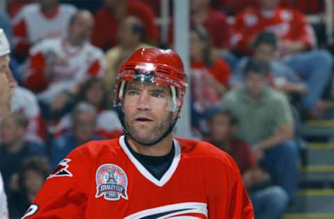 DETROIT, MI – JUNE 6: Defenseman Sean Hill #22 of the Carolina Hurricanes looks on from the ice against the Detroit Red Wings during game 2 of the 2002 Stanley Cup Finals on June 6, 2002 at Joe Louis Arena in Detroit, Michigan. The Red Wings defeated the Hurricanes 3-1. (Photo by Dave Sandford/Getty Images/NHLI)