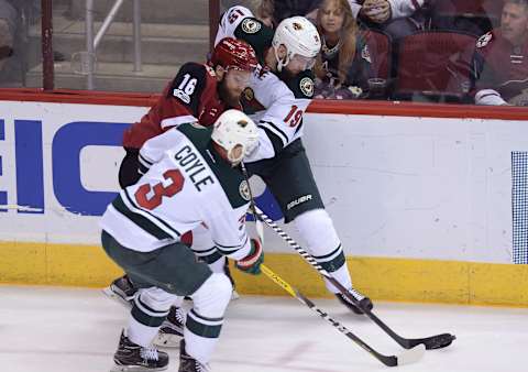 Apr 8, 2017; Glendale, AZ, USA; Minnesota Wild center Martin Hanzal (19) and center Charlie Coyle (3) check Arizona Coyotes left wing Max Domi (16) during the first period at Gila River Arena. The Wild won 3-1. Mandatory Credit: Joe Camporeale-USA TODAY Sports