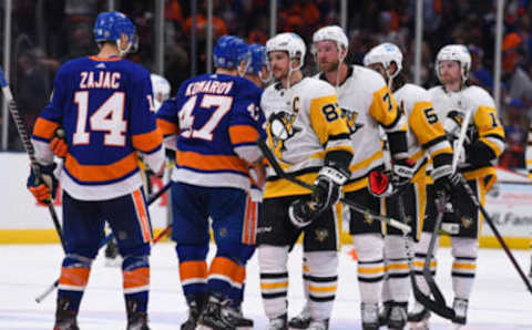 May 26, 2021; Uniondale, New York, USA; Pittsburgh Penguins center Sidney Crosby (87) shakes hands with New York Islanders right wing Leo Komarov (47) after loosing in game six of the first round of the 2021 Stanley Cup Playoffs at Nassau Veterans Memorial Coliseum. Mandatory Credit: Dennis Schneidler-USA TODAY Sports