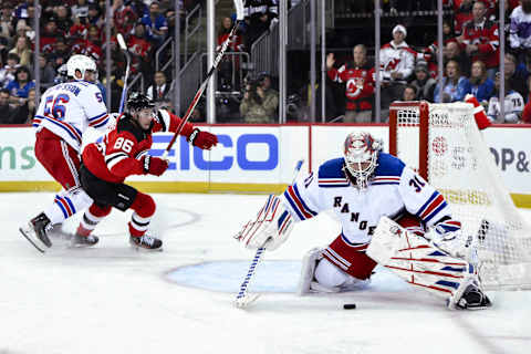 Rangers goaltender Igor Shesterkin makes a save against Devils center Jack Hughes: John Jones-USA TODAY Sports