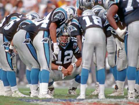 CANTON, OH – JULY 29: Quarterback Kerry Collins #12 of the Carolina Panthers huddles with the offense during a preseason game against the Jacksonville Jaguars at Fawcett Stadium at the Pro Football Hall of Fame on July 29, 1995 in Canton, Ohio. The Panthers defeated the Jaguars 20-14. (Photo by George Gojkovich/Getty Images)