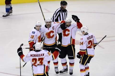 Nov 3, 2015; Denver, CO, USA; Calgary Flames defenseman Mark Giordano (5) celebrates his goal with center Sean Monahan (23) and left wing Johnny Gaudreau (13) and defenseman T.J. Brodie (7) and left wing Jiri Hudler (24) in the third period against the Colorado Avalanche at Pepsi Center. The Avalanche defeated the Flames 6-3. Mandatory Credit: Ron Chenoy-USA TODAY Sports