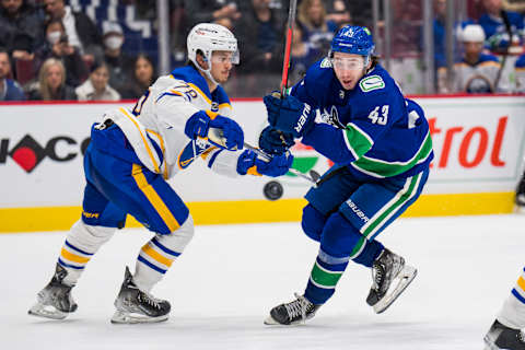 Mar 20, 2022; Vancouver, British Columbia, CAN; Vancouver Canucks defenseman Quinn Hughes (43) skates around Buffalo Sabres defenseman Jacob Bryson (78) in the third period at Rogers Arena. Sabres won 3-2 in overtime. Mandatory Credit: Bob Frid-USA TODAY Sports