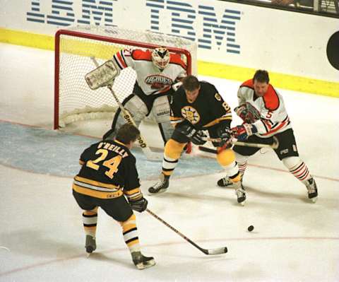 19 Jan 1996: Terry O”Reilly #24 of the Boston Bruin Heroes gets ready to take a shot while teammate Peter McNab #8 fends off Denis Potvin #5 of the NHL Heroes in an attempt to score past goalie John Garrett #31 during the second period of the NHL Heroes