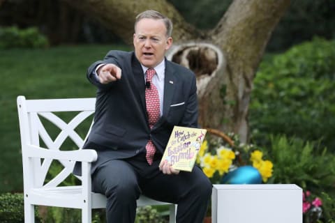 Then-White House Press Secretary Sean Spicer reads a book to children during the White House's annual Easter Egg Roll in 2017.