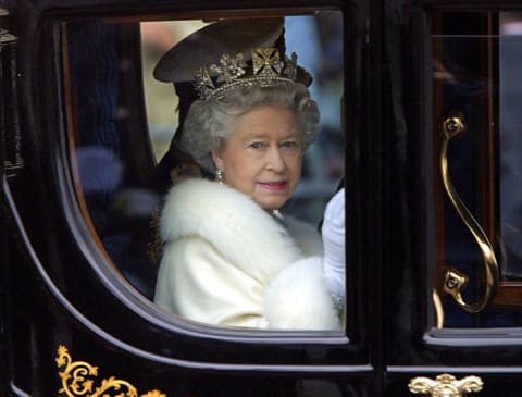 Queen Elizabeth rides in a carriage in 2000.