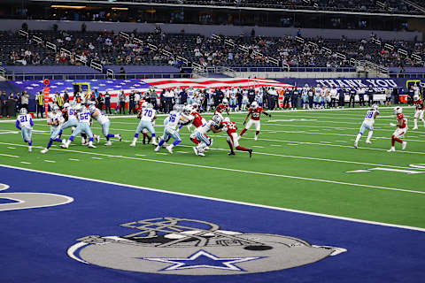 Andy Dalton #14 of the Dallas Cowboys rolls out to pass against the Arizona Cardinals. (Photo by Ronald Martinez/Getty Images)