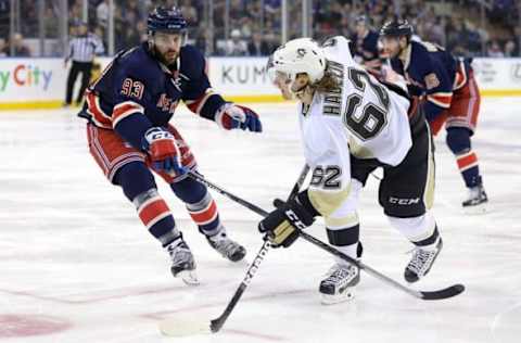 Mar 13, 2016; New York, NY, USA; Pittsburgh Penguins left wing Carl Hagelin (62) shoots the puck in front of New York Rangers defenseman Keith Yandle (93) during the thirdperiod at Madison Square Garden. The Penguins won 5-3. Mandatory Credit: Vincent Carchietta-USA TODAY Sports