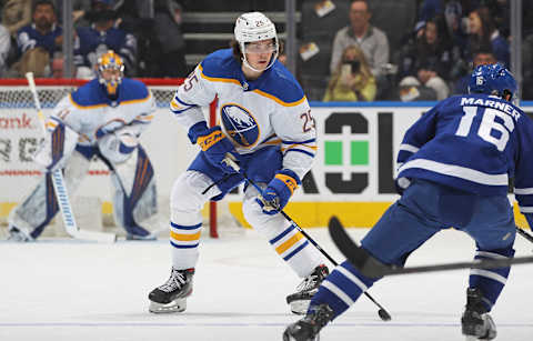 TORONTO, ON – APRIL 12: Owen Power #25 of the Buffalo Sabres skates in his 1st NHL game against an attacking Mitchell Marner #16 of the Toronto Maple Leafs at Scotiabank Arena on April 12, 2022 in Toronto, Ontario, Canada. The Sabres defeated the Maple Leafs 5-2. (Photo by Claus Andersen/Getty Images)