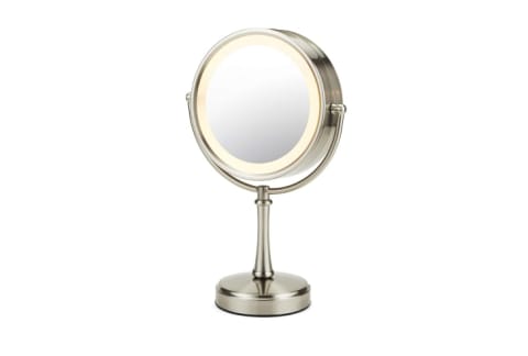 A round makeup mirror with a lighted edge