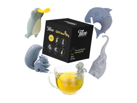 Tea infusers shaped like a platypus, a shark, a squirrel, a monkey, and an elephant with a cup of tea