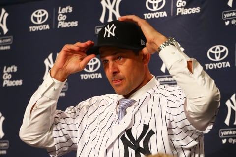 NEW YORK, NY – DECEMBER 06: Aaron Boone puts on a Yankee cap after being introduced as manager of the New York Yankees at Yankee Stadium on December 6, 2017 in the Bronx borough of New York City. (Photo by Mike Stobe/Getty Images)