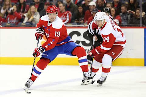 Feb 9, 2017; Washington, DC, USA; Washington Capitals center Nicklas Backstrom (19) skates with the puck past Detroit Red Wings center Gustav Nyquist (14) in the second period at Verizon Center. The Capitals won 6-3. Mandatory Credit: Geoff Burke-USA TODAY Sports