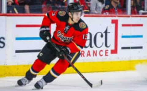 Apr 7, 2016; Calgary, Alberta, CAN; Calgary Flames left wing Johnny Gaudreau (13) skates with the puck against the Vancouver Canucks during the second period at Scotiabank Saddledome. Calgary Flames won 7-3. Mandatory Credit: Sergei Belski-USA TODAY Sports