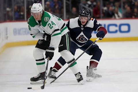 DENVER, COLORADO – JANUARY 14: Roope Hinz #24 of the Dallas Stars fights for the puck against Cale Makar #8 of the Colorado Avalanche in the second period at the Pepsi Center on January 14, 2020 in Denver, Colorado. (Photo by Matthew Stockman/Getty Images)