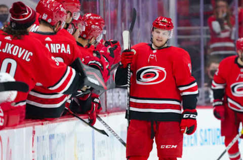 Apr 29, 2021; Raleigh, North Carolina, USA; Carolina Hurricanes left wing Warren Foegele (13) scores a second period goal against the Detroit Red Wings at PNC Arena. Mandatory Credit: James Guillory-USA TODAY Sports