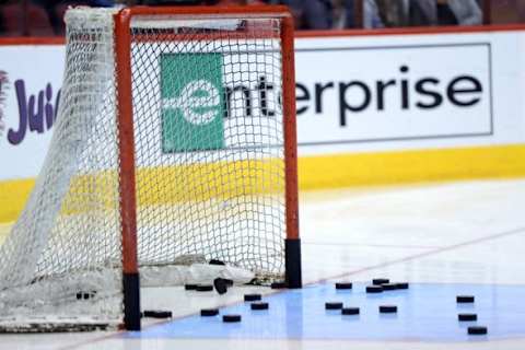 Jan 6, 2015; Glendale, AZ, USA; Pucks lie in the crease and net before the game between the Arizona Coyotes and the St. Louis Blues at Gila River Arena. The Blues won 6-0. Mandatory Credit: Joe Camporeale-USA TODAY Sports