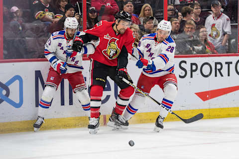 Apr 8, 2017; Ottawa, Ontario, CAN; Ottawa Senators defenseman Cody Ceci (5) battles with New York Rangers right wing Brandon Pirri (73) and left wing Taylor Beck (28) for control of the puck in the first period at Canadian Tire Centre. Mandatory Credit: Marc DesRosiers-USA TODAY Sports