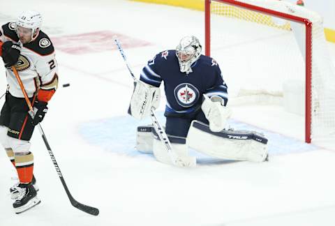 Anaheim Ducks, Sam Steel (23); Winnipeg Jets, Connor Hellebuyck (37). Mandatory Credit: Terrence Lee-USA TODAY Sports