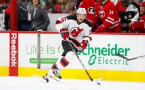 Dec 26, 2015; Raleigh, NC, USA; New Jersey Devils forward Tuomo Ruutu (15) skates with the puck against the Carolina Hurricanes at PNC Arena. The Carolina Hurricanes defeated the New Jersey Devils 3-1. Mandatory Credit: James Guillory-USA TODAY Sports