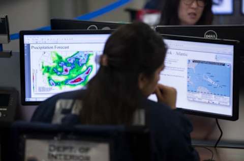 WASHINGTON, DC – AUGUST 4: (AFP OUT) Employees sit in front of computer monitors at the command center of the Federal Emergency Management Agency (FEMA) headquarters, shortly before a visit by U.S. President Donald Trump (not pictured) on August 4, 2017 in Washington, DC. Trump visited FEMA headquarters to receive a briefing on the hurricane season. (Photo by Michael Reynolds – Pool/Getty Images)