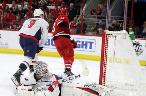 RALEIGH, NC – MARCH 28: Warren Foegele #13 of the Carolina Hurricanes scores a goal as Braden Holtby #70 of the Washington Capitals looks back at the puck in the net during an NHL game on March 28, 2019 at PNC Arena in Raleigh, North Carolina. (Photo by Gregg Forwerck/NHLI via Getty Images)