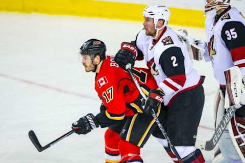 Jan 7, 2016; Calgary, Alberta, CAN; Calgary Flames left wing Lance Bouma (17) and Arizona Coyotes defenseman Nicklas Grossmann (2) fight for position during the second period at Scotiabank Saddledome. Arizona Coyotes won 2-1. Mandatory Credit: Sergei Belski-USA TODAY Sports