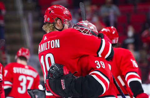 May 1, 2021; Raleigh, North Carolina, USA; Carolina Hurricanes defenseman Dougie Hamilton (19) and goaltender Alex Nedeljkovic (39) celebrate there win against the Columbus Blue Jackets at PNC Arena. Mandatory Credit: James Guillory-USA TODAY Sports