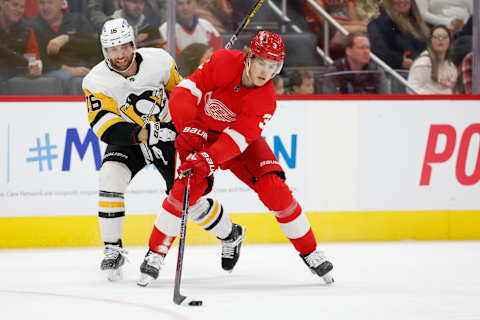 Oct 3, 2022; Detroit, Michigan, USA; Detroit Red Wings defenseman Simon Edvinsson (3) skates with the puck defended by Pittsburgh Penguins left wing Jason Zucker (16) in the third period at Little Caesars Arena. Mandatory Credit: Rick Osentoski-USA TODAY Sports