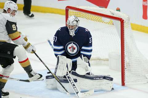 Vegas Golden Knights, Jack Eichel (9); Winnipeg Jets, Connor Hellebuyck (37). Mandatory Credit: Terrence Lee-USA TODAY Sports