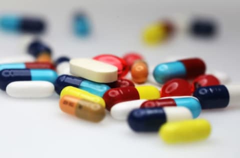 Brightly coloured pharmaceutical medication, including antibiotics, paracetamol, Ibuprofen and cold relief tablets, manufactured by a variety of companies sit in this arranged photograph in London, U.K., on Friday, April 27, 2018. Pharmaceutical companies may see approval times cut to 14 months vs. 19 and about $370 million of sales brought forward per antibiotic after global regulators aligned rules to combat bacterial resistance. Photographer: Chris Ratcliffe/Bloomberg via Getty Images