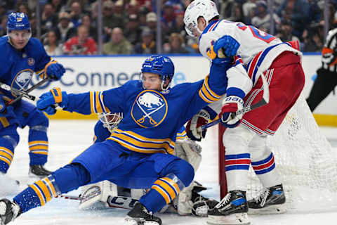 BUFFALO, NY – OCTOBER 12: Peyton Krebs #19 of the Buffalo Sabres protects the net as Kaapo Kakko #24 of the New York Rangers looks for a rebound during the third period at KeyBank Center on October 12, 2023 in Buffalo, New York. (Photo by Kevin Hoffman/Getty Images)