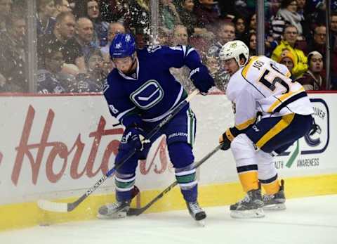 Jan 26, 2016; Vancouver, British Columbia, CAN; Vancouver Canucks forward Jake Virtanen (18) battles for the puck against Nashville Predators defenseman Roman Josi (59) during the first period at Rogers Arena. Mandatory Credit: Anne-Marie Sorvin-USA TODAY Sports