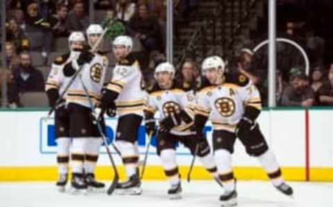 Feb 26, 2017; Dallas, TX, USA; Boston Bruins defenseman Brandon Carlo (25) and defenseman Zdeno Chara (33) and center David Backes (42) and left wing Brad Marchand (63) and center Patrice Bergeron (37) celebrate a goal against the Dallas Stars during the second period at the American Airlines Center. Mandatory Credit: Jerome Miron-USA TODAY Sports