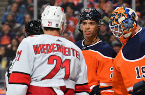 EDMONTON, AB – DECEMBER 10: Darnell Nurse #25 of the Edmonton Oilers exchanges words with Nino Niederreiter #21 of the Carolina Hurricanes on December 10, 2019, at Rogers Place in Edmonton, Alberta, Canada. (Photo by Andy Devlin/NHLI via Getty Images)