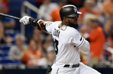 May 28, 2017; Miami, FL, USA; Miami Marlins left fielder Marcell Ozuna (13) connects for an RBI single during the eighth inning against the Los Angeles Angels at Marlins Park. Mandatory Credit: Steve Mitchell-USA TODAY Sports