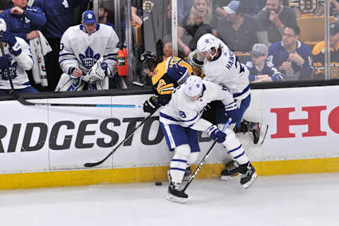 BOSTON, MA – APRIL 13: Boston Bruins right wing David Pastrnak (88) gets pinned up again the boars by Toronto Maple Leafs right wing Mitchell Marner (16), and Toronto Maple Leafs defenseman Ron Hainsey (2). During Game 2 in the First round of the Stanley Cup playoffs featuring the Boston Bruins against the Toronto Maple Leafs on April 13, 2019 at TD Garden in Boston, MA. (Photo by Michael Tureski/Icon Sportswire via Getty Images)