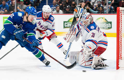 VANCOUVER, BC – NOVEMBER 2: Vasily Podkolzin #92 of the Vancouver Canucks tries to put a backhand shot on goalie Igor Shesterkin #31 of the New York Rangers after getting past Alexis Lafreniere #13 during the second period on November, 2, 2021 at Rogers Arena in Vancouver, British Columbia, Canada. (Photo by Rich Lam/Getty Images)