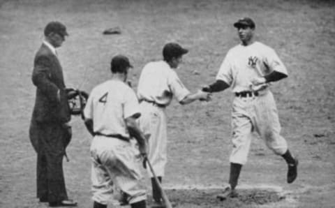 Joe DiMaggio crosses home plate after hitting a home run in 1938; No. 4 waiting to greet him is Lou Gehrig.. (Photo by Mark Rucker/Transcendental Graphics, Getty Images)