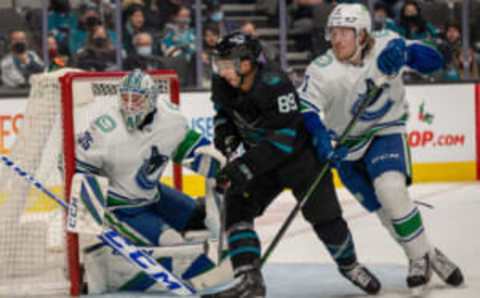 Dec 16, 2021; San Jose, California, USA; San Jose Sharks left wing Jayden Halbgewachs (89) and Vancouver Canucks right wing Brock Boeser (6) battle for position in front of the net during the second period at SAP Center at San Jose. Mandatory Credit: Neville E. Guard-USA TODAY Sports