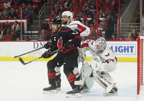 RALEIGH, NC – DECEMBER 14: Justin Williams #14 of the Carolina Hurricanes creates traffic near the crease as Matt Niskanen #2 of the Washington Capitals defends and teammate Braden Holtby #70 crouches to protect the net during an NHL game on December 14, 2018 at PNC Arena in Raleigh, North Carolina. (Photo by Gregg Forwerck/NHLI via Getty Images)