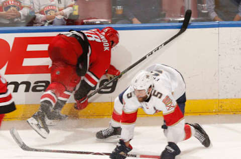 SUNRISE, FL – FEBRUARY 21: Jordan Martinook #48 of the Carolina Hurricanes and Aaron Ekblad #5 of the Florida Panthers collide along with the board during third-period action at the BB&T Center on February 21, 2019, in Sunrise, Florida. The Hurricanes defeated the Panthers 4-3. (Photo by Joel Auerbach/Getty Images)